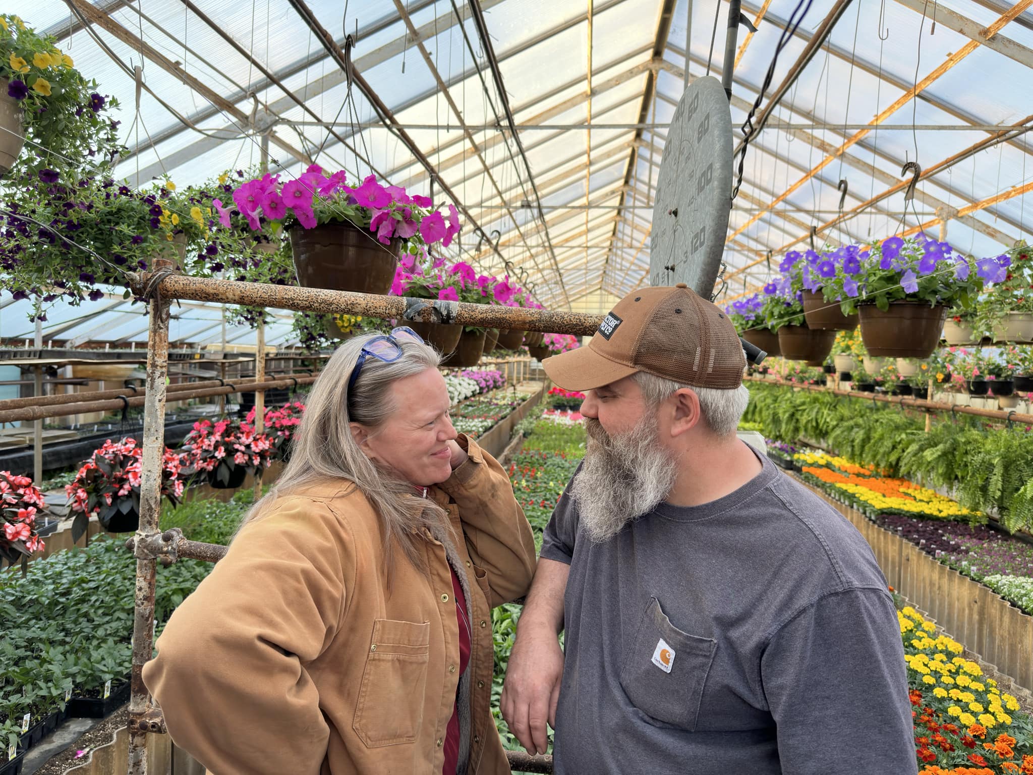 Jules and Scott of Steve's Greenhouse looking at each other